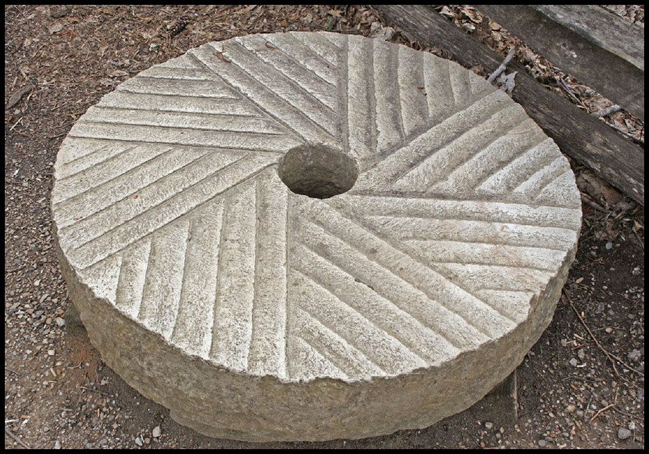 A taper-grooved millstone